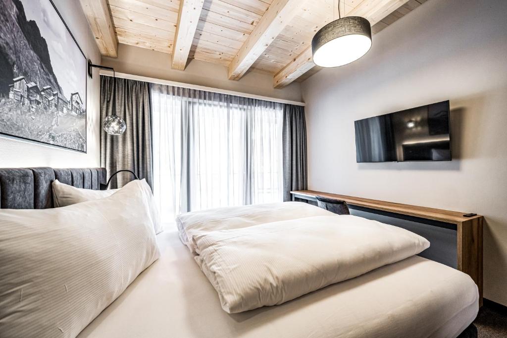 Posteľ alebo postele v izbe v ubytovaní Sonnalp Residences