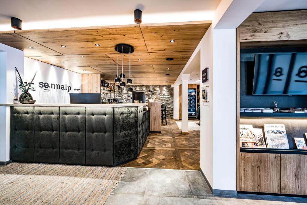 a restaurant with a bar with leather seats at Sonnalp Residences in Sölden