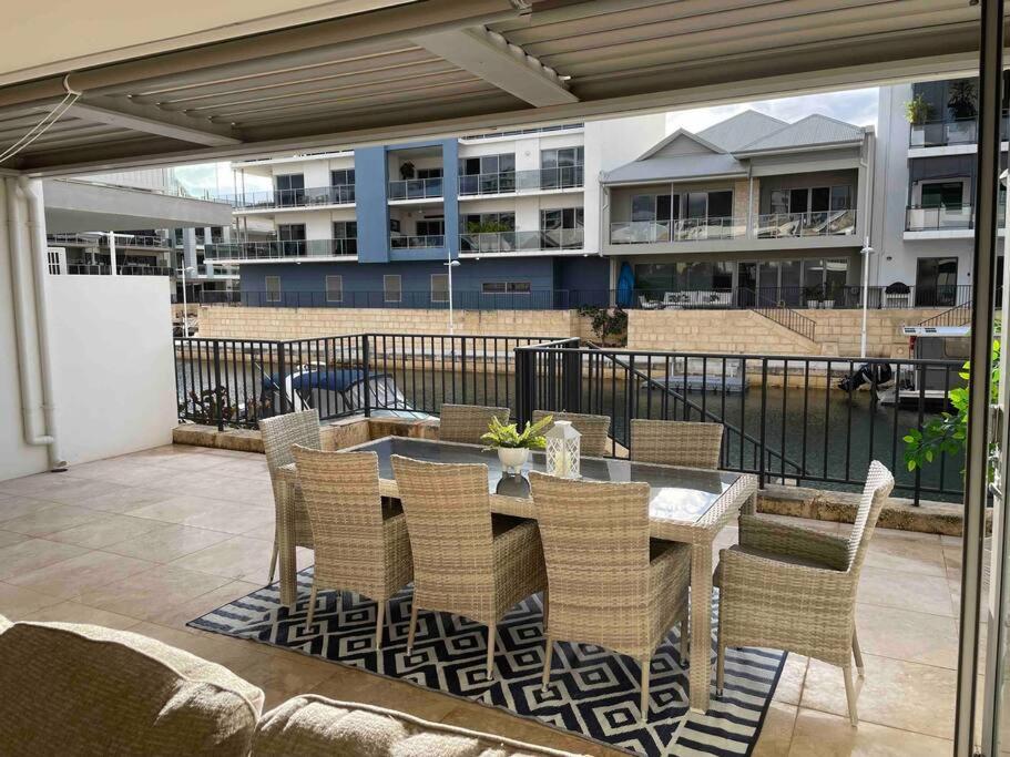 a patio with a table and chairs on a balcony at Canal Vista in Mandurah