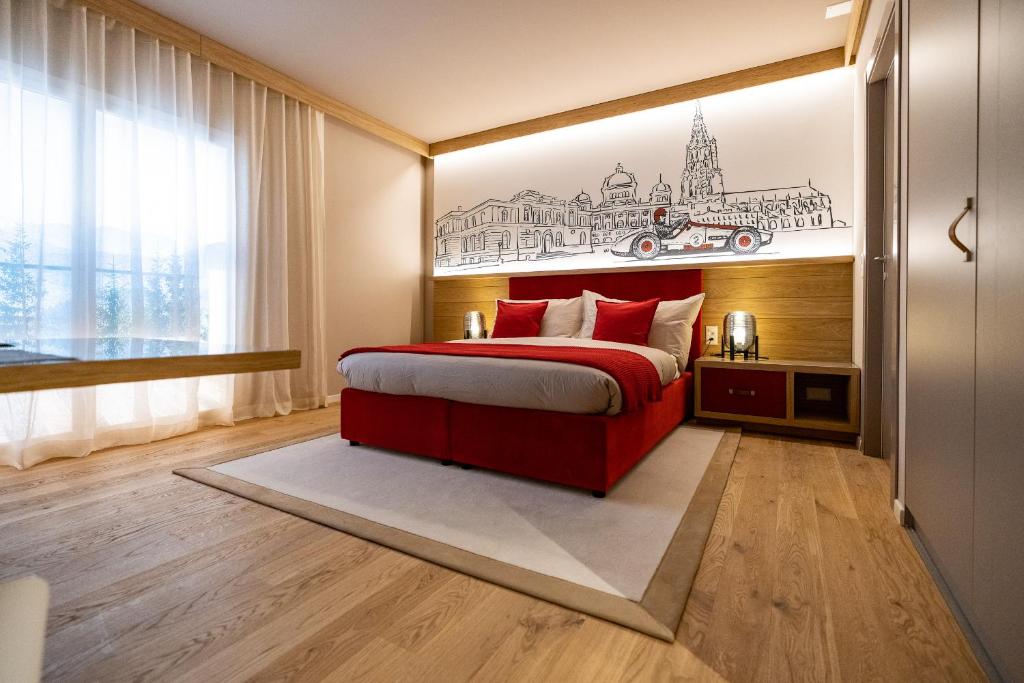 a bedroom with a red bed with a drawing on the wall at NEW OPENING 2022 - Los Lorentes Apartments Bern City in Bern