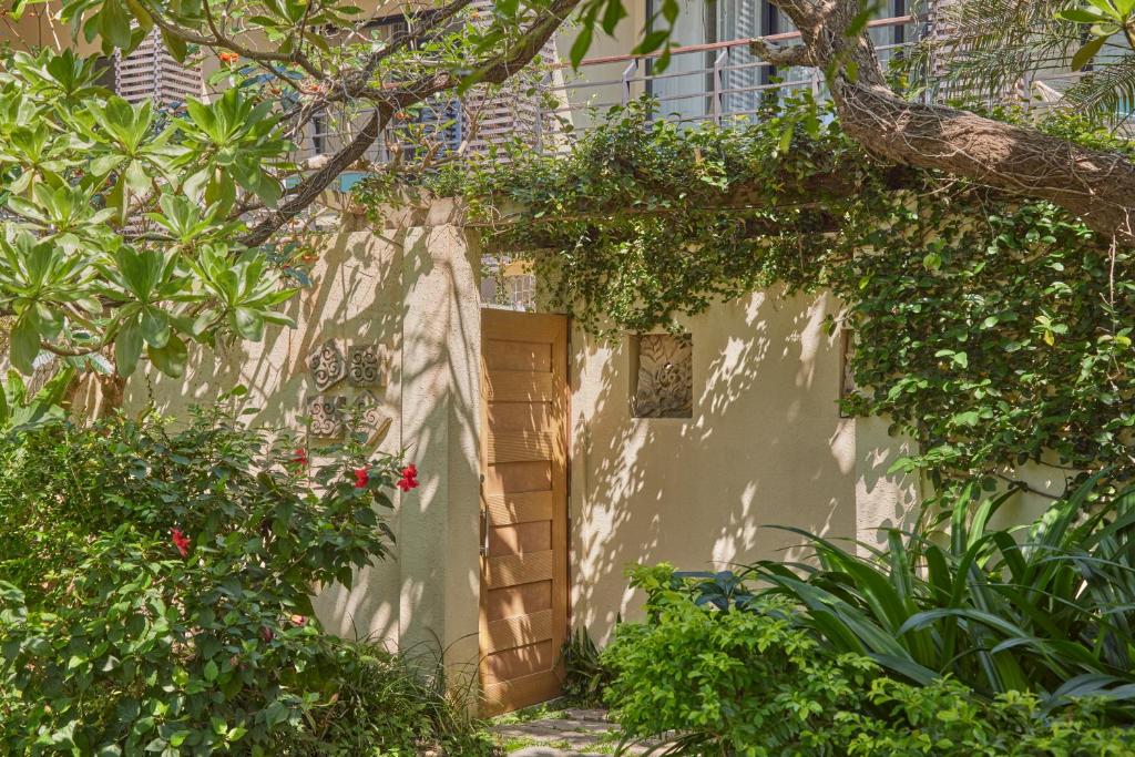 a white building with a door and some plants at Caesar Park Hotel Kenting in Kenting