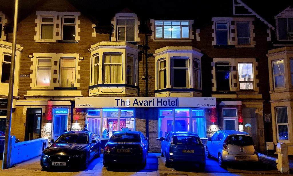 a group of cars parked in front of a building at The Avari Beach Hotel in Blackpool
