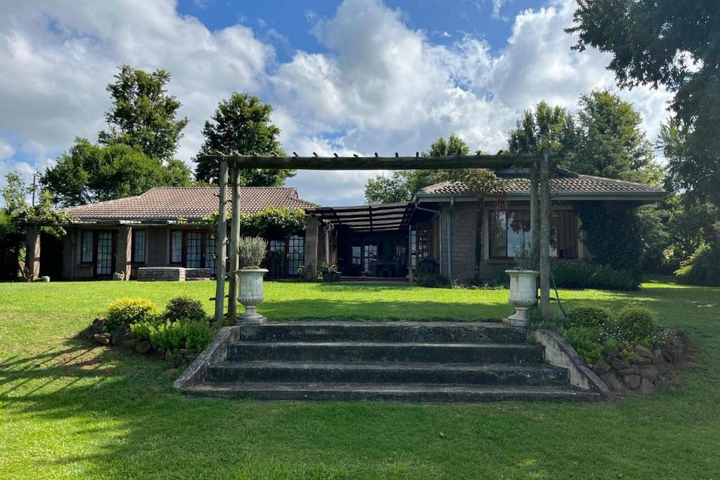 a house with a gazebo in a yard at Wellstead in Champagne Valley in Cathkin Park