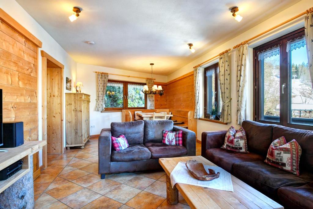 a living room with a couch and a table at Apartments Landhaus Sonnheim in Lofer