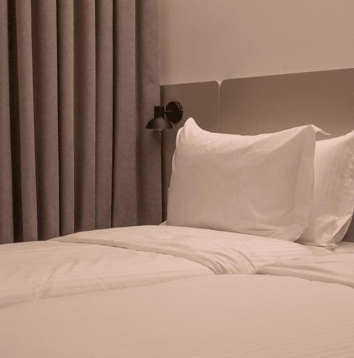 Postel nebo postele na pokoji v ubytování Hotel Theatro- City Center