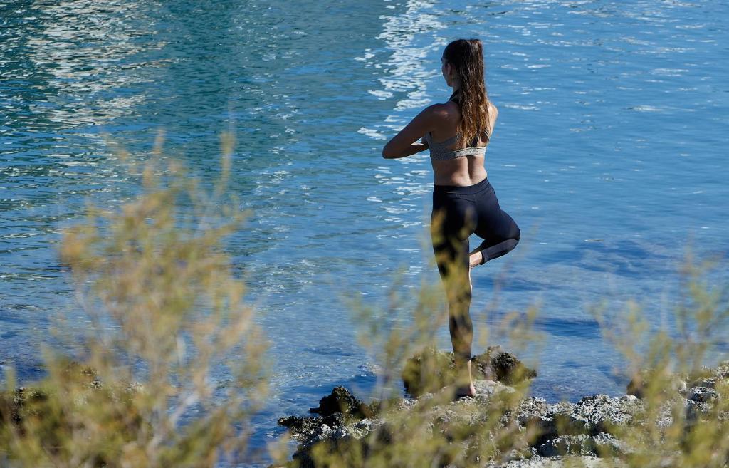 a woman standing in the water near the water at Vasia Resort & Spa in Sisi