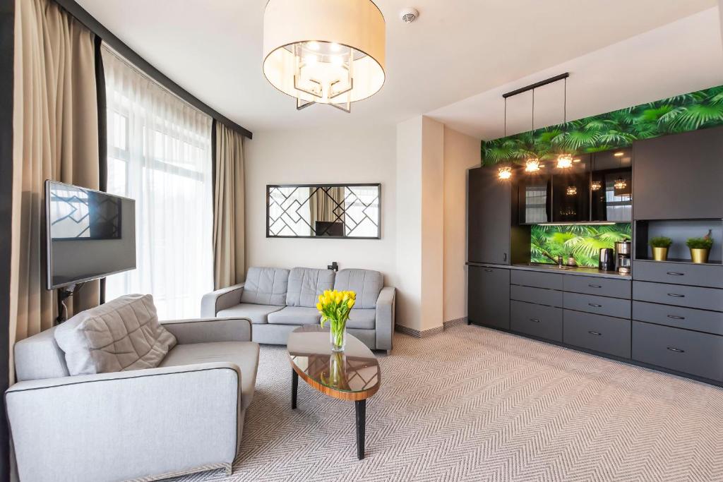 salon z kanapą i telewizorem w obiekcie VacationClub – Diune Resort Apartament 312 w Kołobrzegu