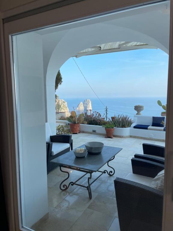 Zimmer mit einem Tisch und Meerblick in der Unterkunft Villa le stelle capri in Capri