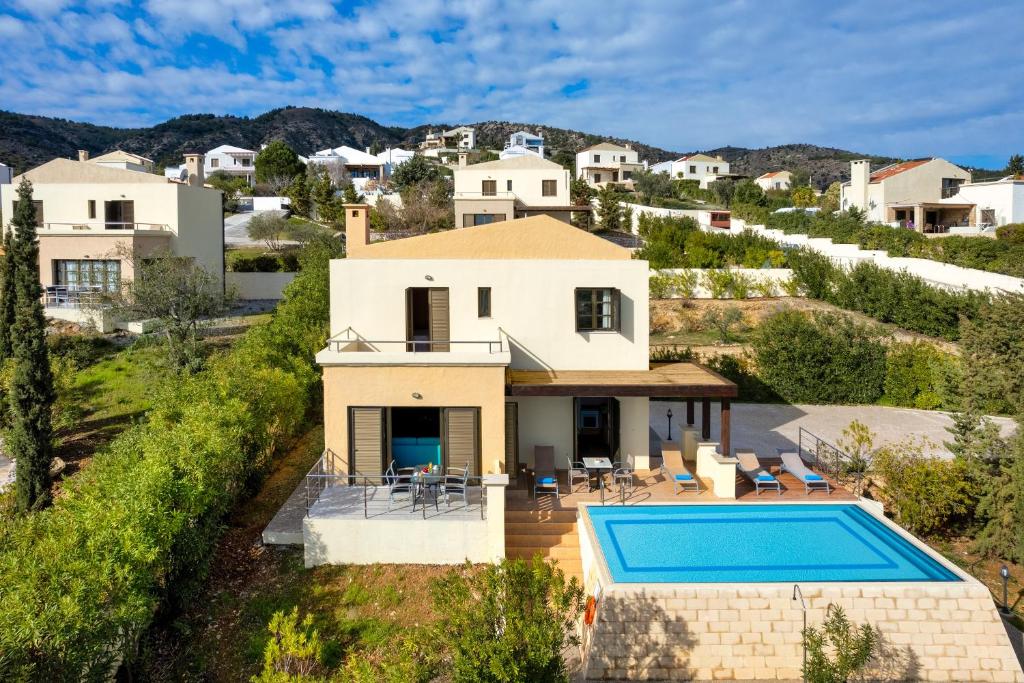 an aerial view of a villa with a swimming pool at Aegean Blue Villa's - All Inclusive & Water park in Kalathos