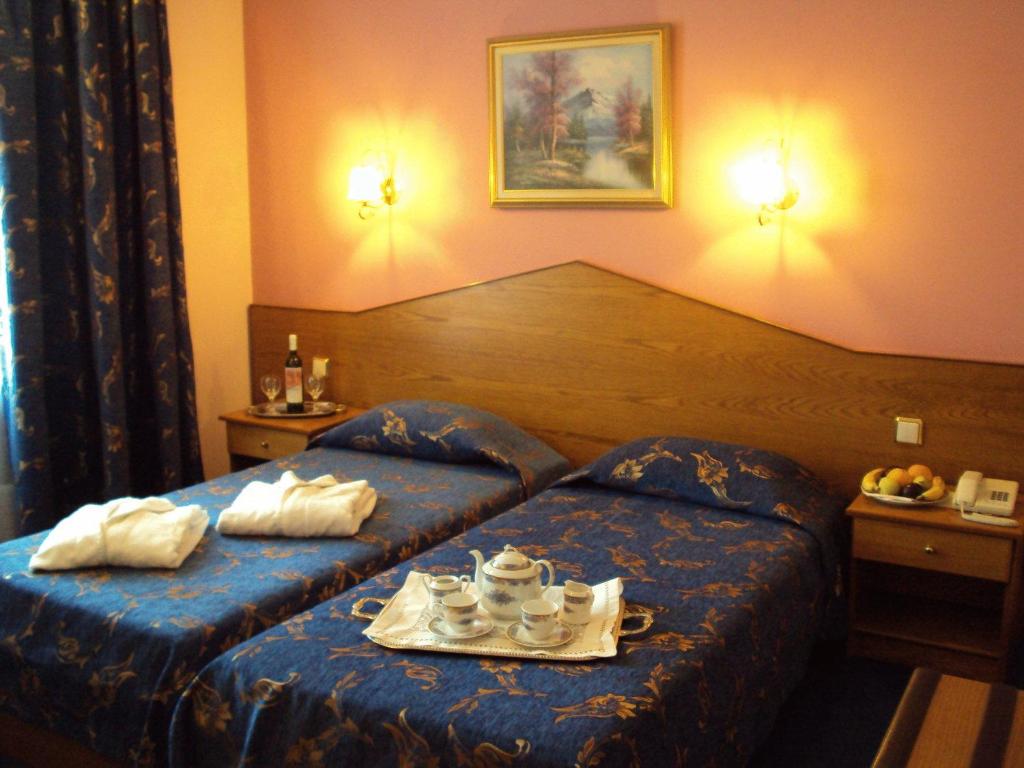 a hotel room with a bed with a tray of tea sets at Astoria Hotel Traditional in Komotini
