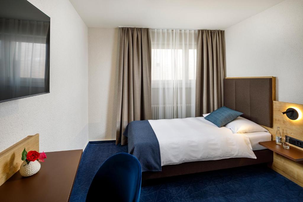Postel nebo postele na pokoji v ubytování Hotel Tivoli