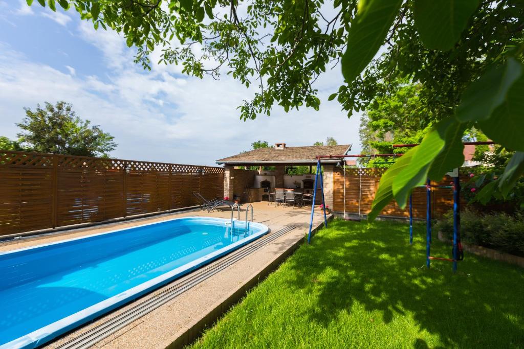 a swimming pool in the backyard of a house at Lubi Lodge in Balatonboglár