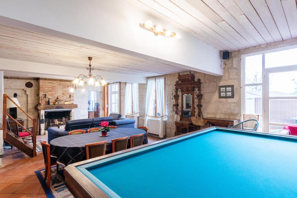 a living room with a pool table and a couch at La Pierre Blanche 