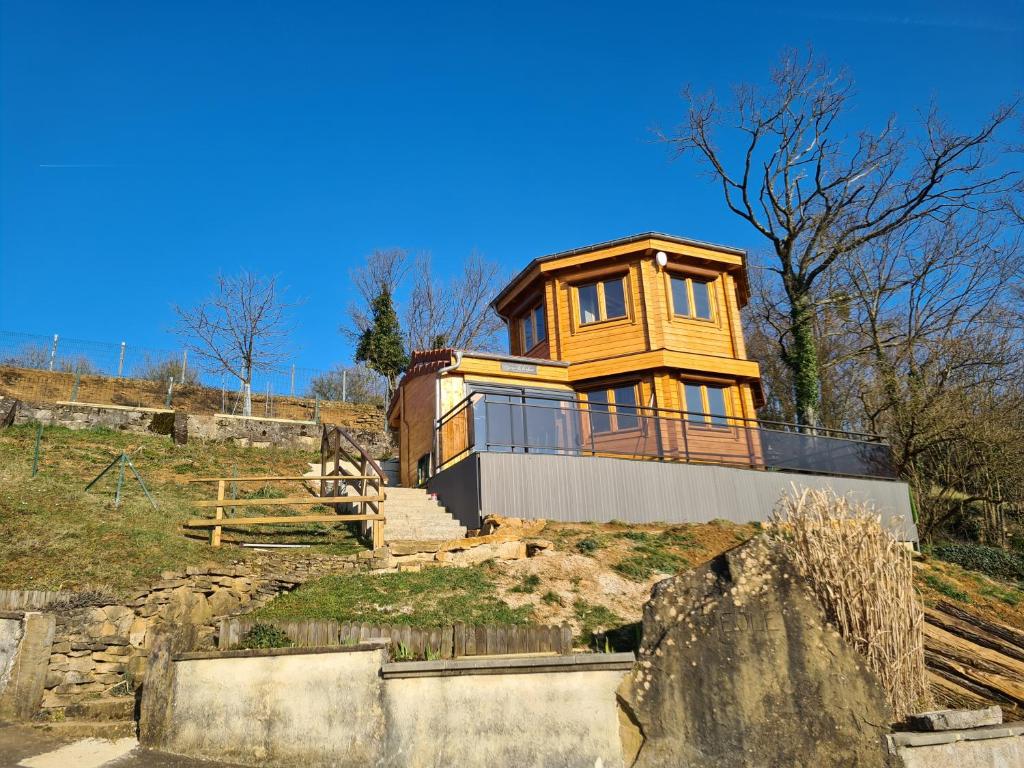 a house sitting on top of a hill at Gite chalet Au Paradis d Eole 