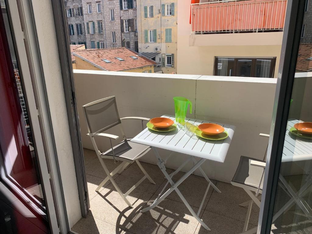 a balcony with a table and chairs on a balcony at Appartement Fodéré 2 in Nice
