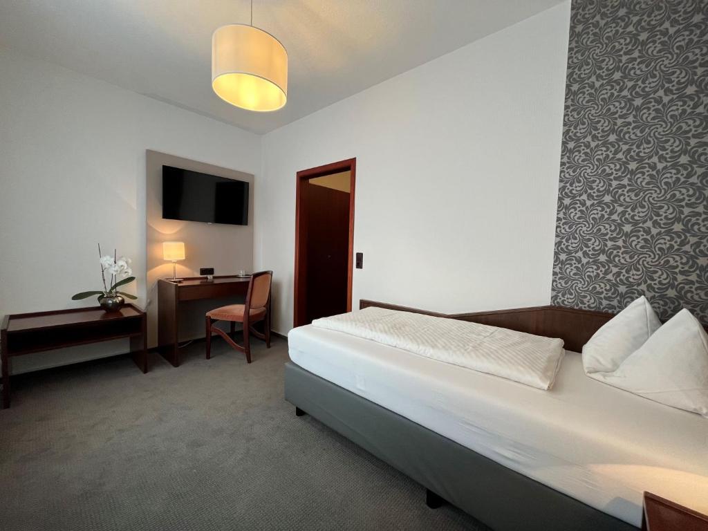 Postel nebo postele na pokoji v ubytování Hotel Garni Geisler