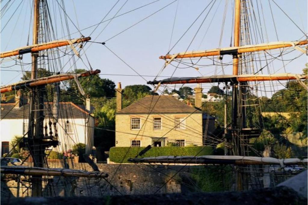 two tall ships docked in front of a house at Antonia's Pearls in St Austell