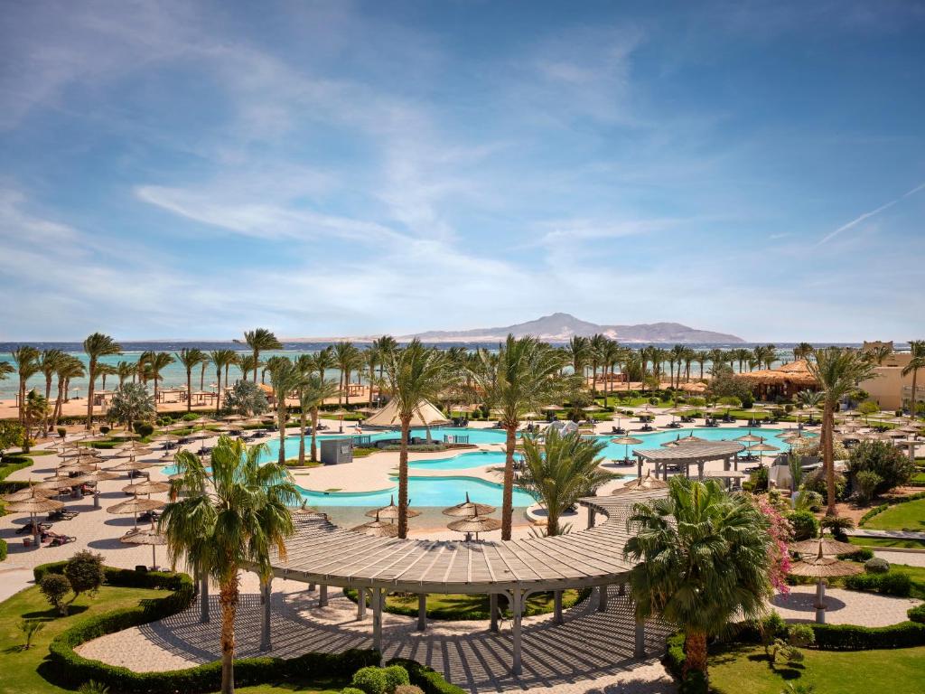 an aerial view of a resort with palm trees and pools at Coral Sea Waterworld Sharm El Sheikh in Sharm El Sheikh