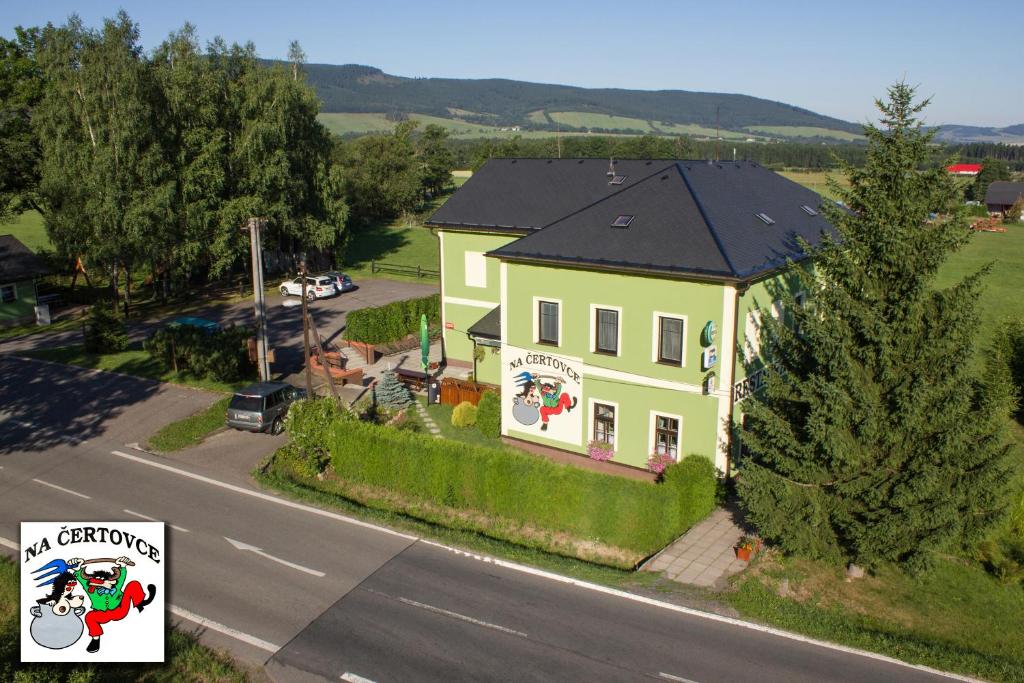 a house with a christmas sign in front of it at Penzion na Čertovce in Dolní Orlice