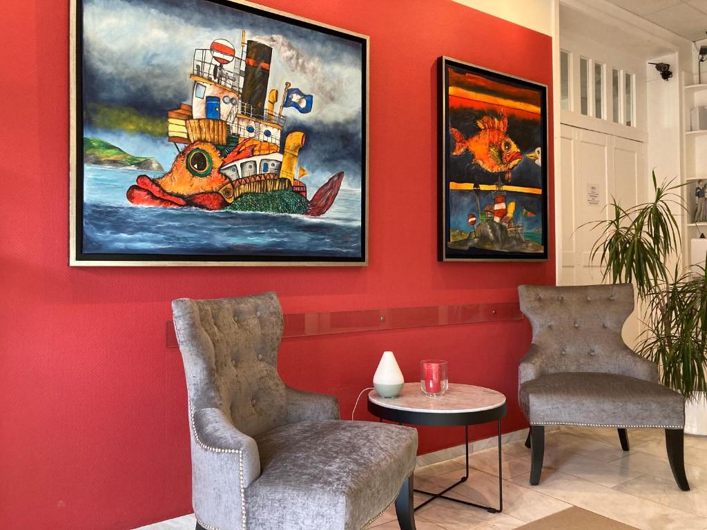 a room with two chairs and a painting on the wall at Hotel Diamant in Wedel