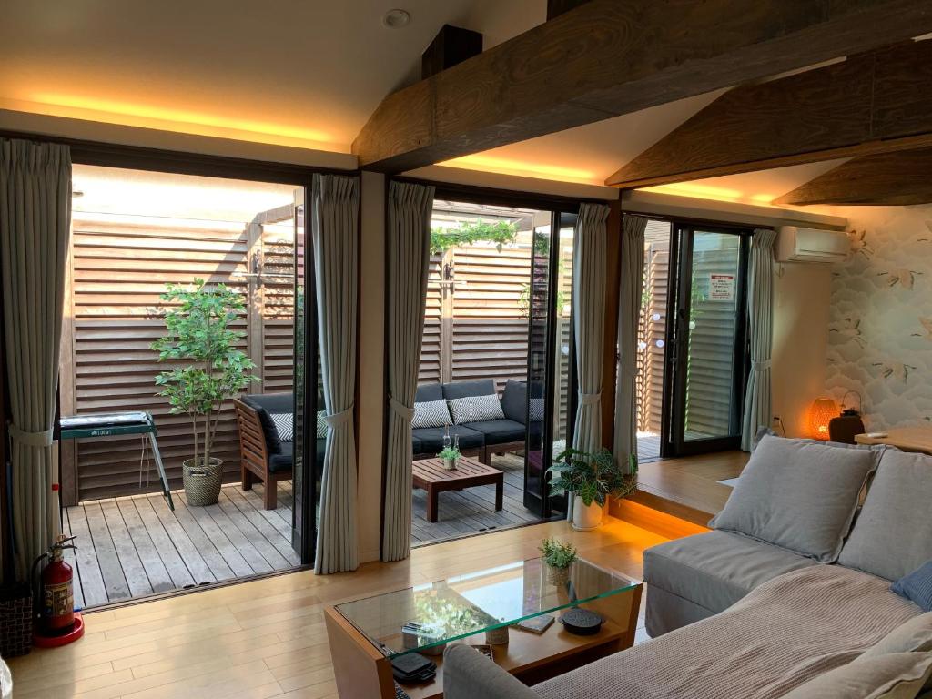 a living room with a couch and a glass table at ASAKUSA EAST Terrace - KANDO in Tokyo