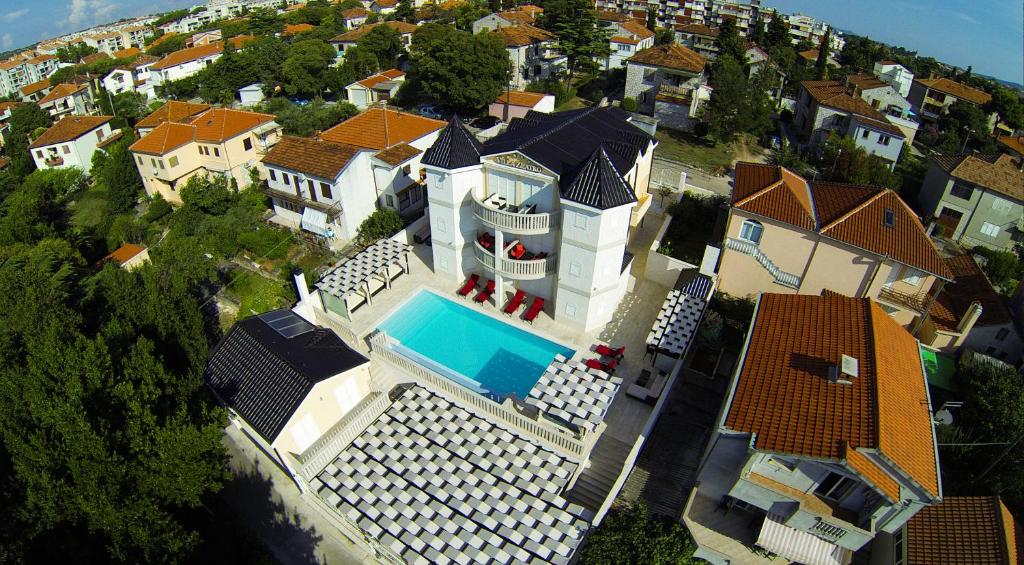 an aerial view of a house with a swimming pool at Apartments Villa Zlatko in Zadar