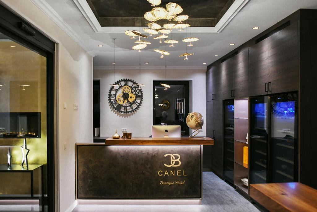 a luxury dressing room with a counter and a clock on the wall at Boutique Hotel Canel in Würzburg