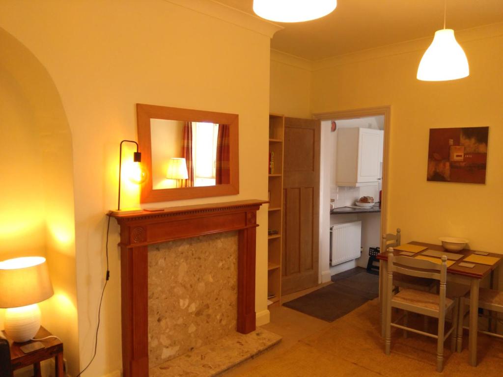 a living room with a fireplace and a mirror at Apartment with Outside Patio and Car Space in Durham