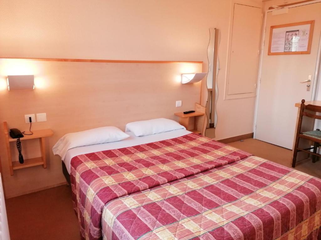 Postel nebo postele na pokoji v ubytování Les Charmilles
