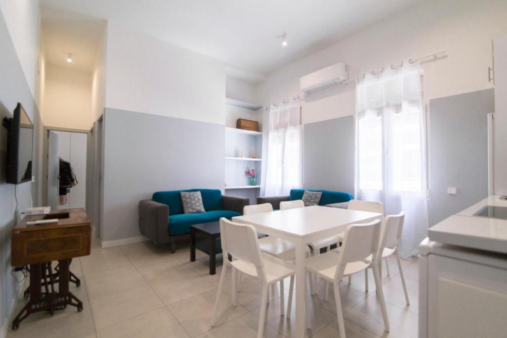 sala de estar con mesa blanca y sillas en Minty Stay - Velarde, en Madrid
