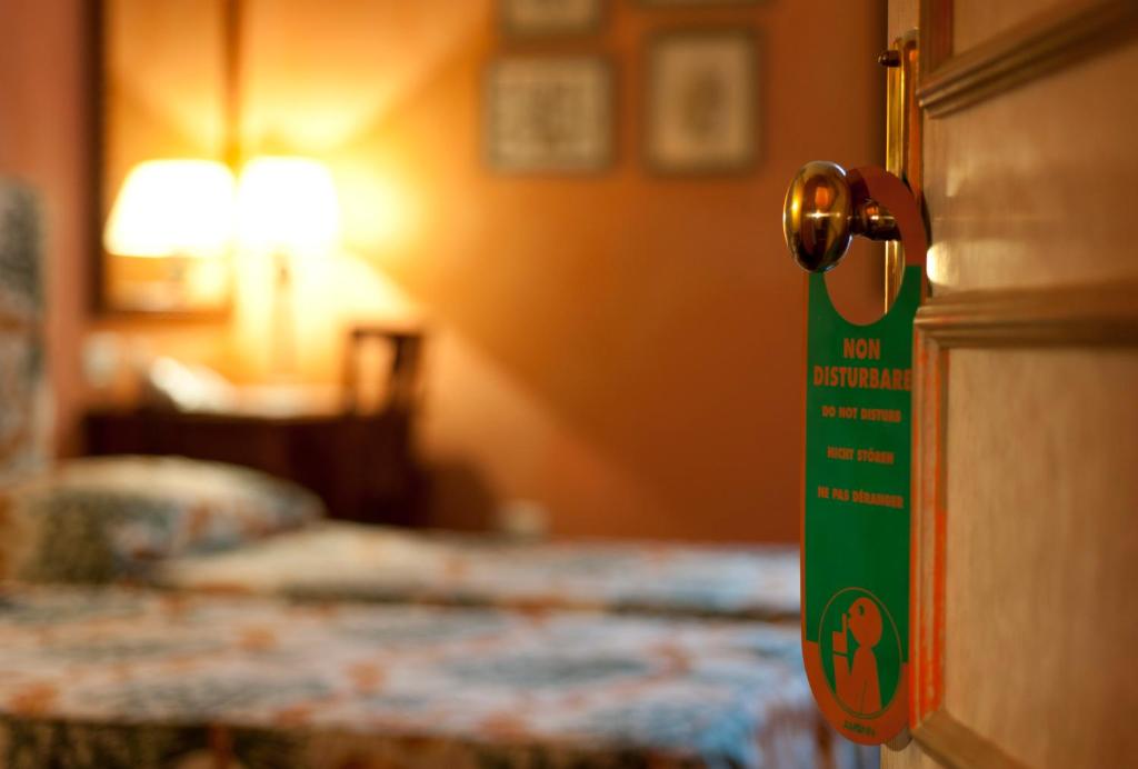 Postel nebo postele na pokoji v ubytování Hotel Vecchio Borgo