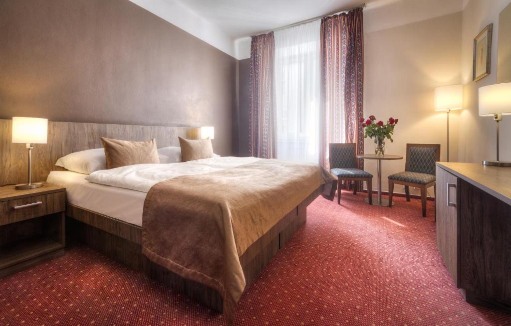 Postel nebo postele na pokoji v ubytování Hotel Harmony