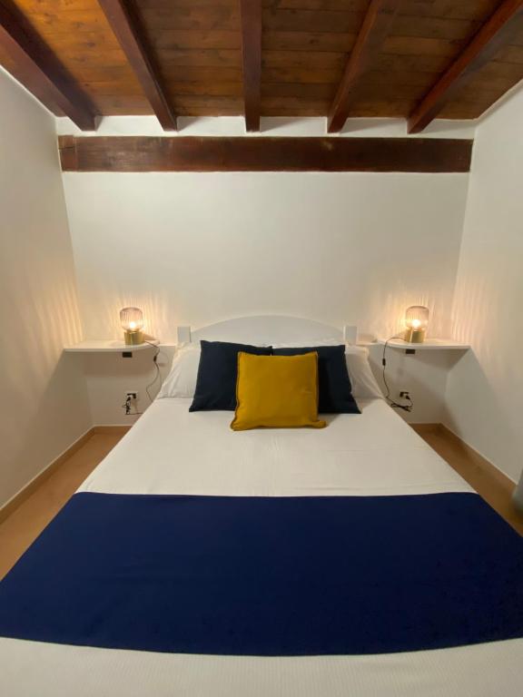 a bedroom with a blue and white bed with a yellow pillow at Casa Vacanza Porta Smeralda in Olbia