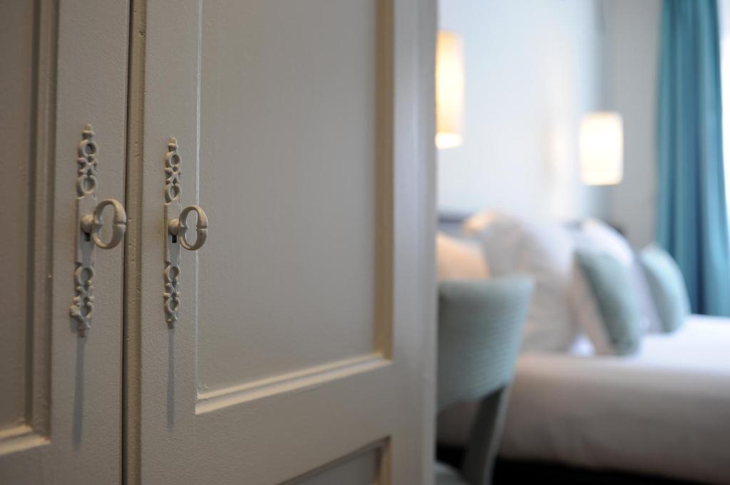 Postel nebo postele na pokoji v ubytování Hotel Albert 1er