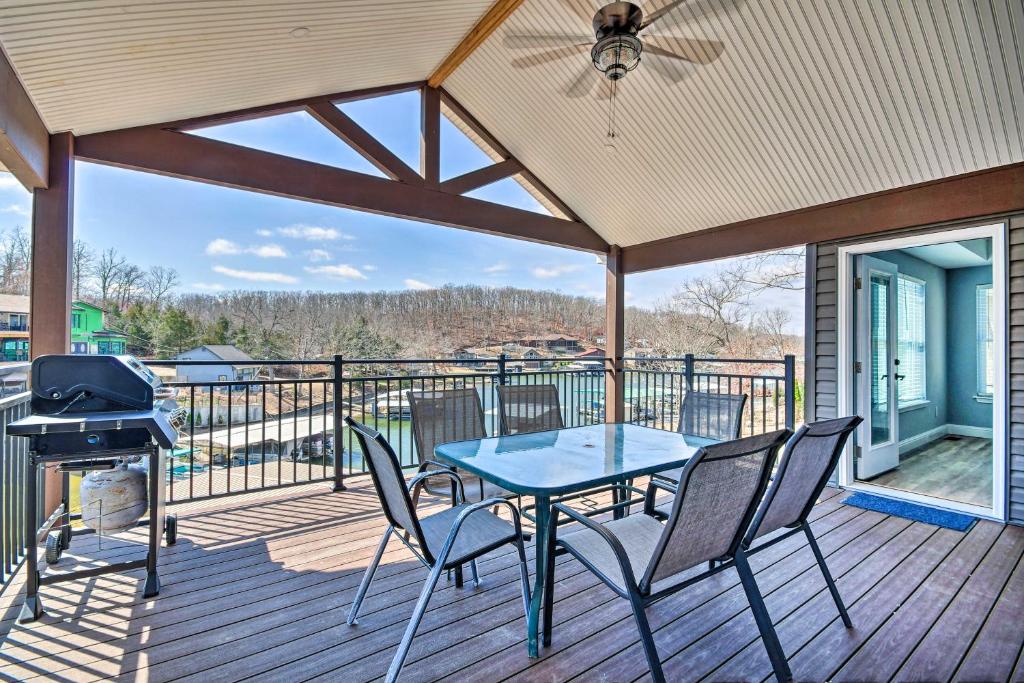 a patio with a table and chairs and a grill at Lakefront Rocky Mount Home with Dock and Fire Pit in Rocky Mount