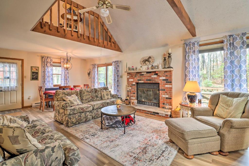 a living room with a couch and a fireplace at Secluded Poconos Home with Decks about 1 Mi to Lake in Jim Thorpe