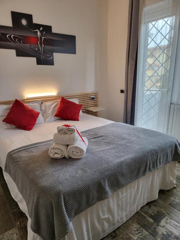 a bedroom with a bed with towels on it at THAT'S AMORE FIUMICINO Airport in Fiumicino