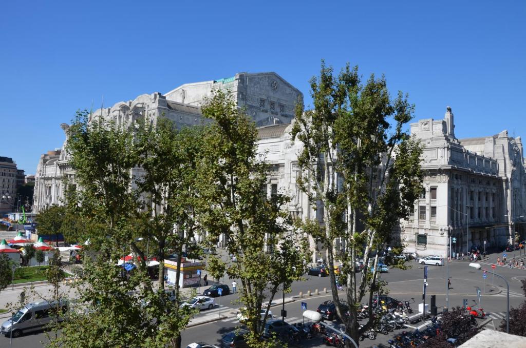 eine Stadtstraße mit Bäumen vor den Gebäuden in der Unterkunft Il Giramondo in Mailand