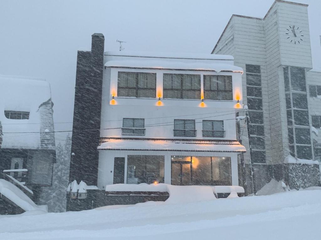 a tall building with a clock on it in the snow at Minamiuonuma - Hotel - Vacation STAY 36571v in Seki