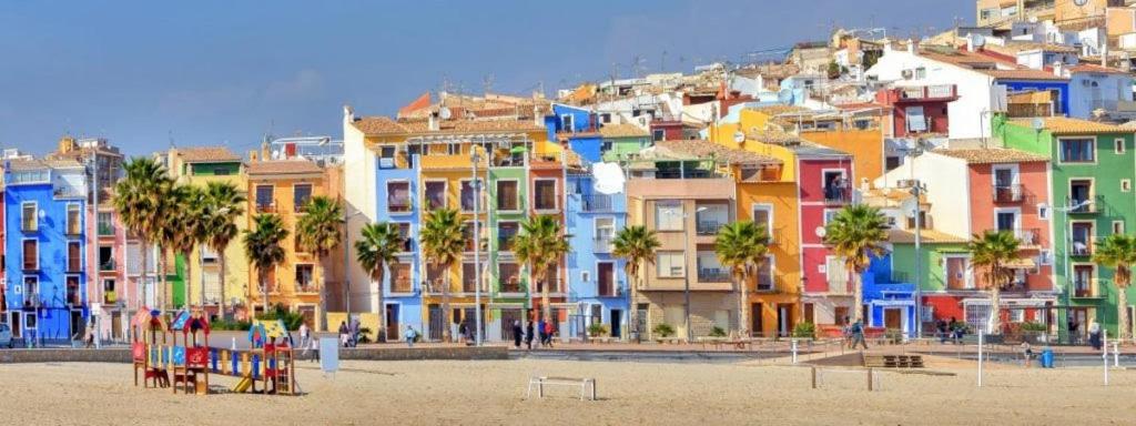 a group of colorful buildings on a beach at Beach front Esther 4 villajoyosa in Villajoyosa