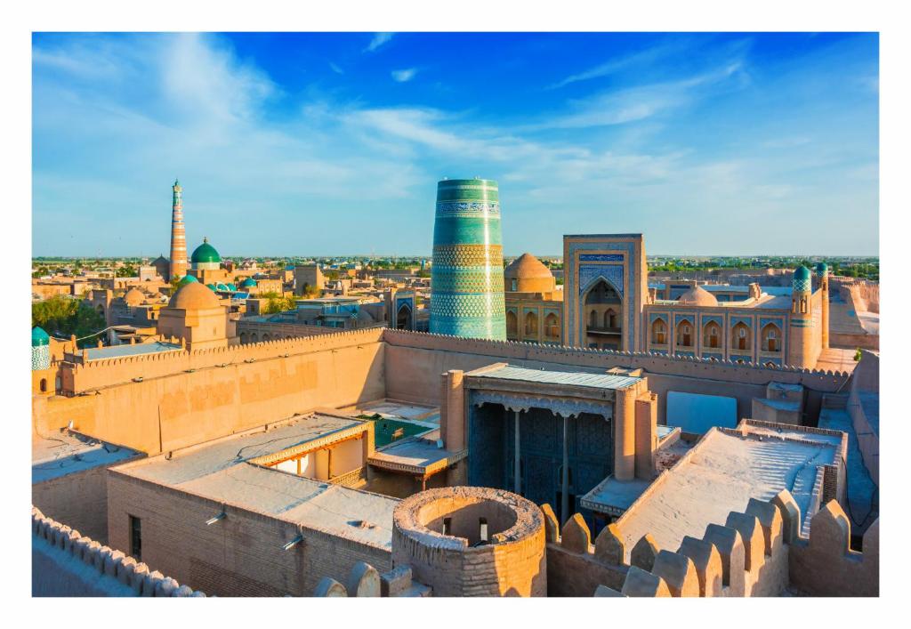 an aerial view of a city with buildings and mosques at Khiva Ibrohim Guest House in Khiva