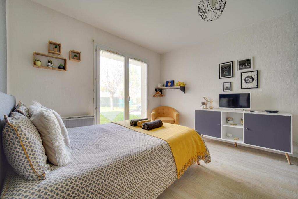 - une chambre avec un lit et une couverture jaune dans l'établissement Le studio d'Angèle, à Bruz