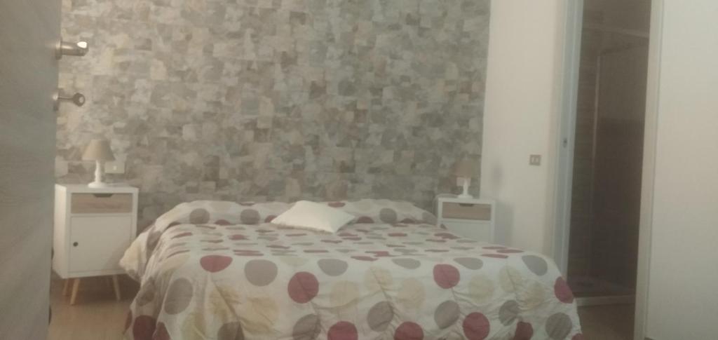 a bedroom with a large bed with two night stands at B&B Dolci Notti in Budoni
