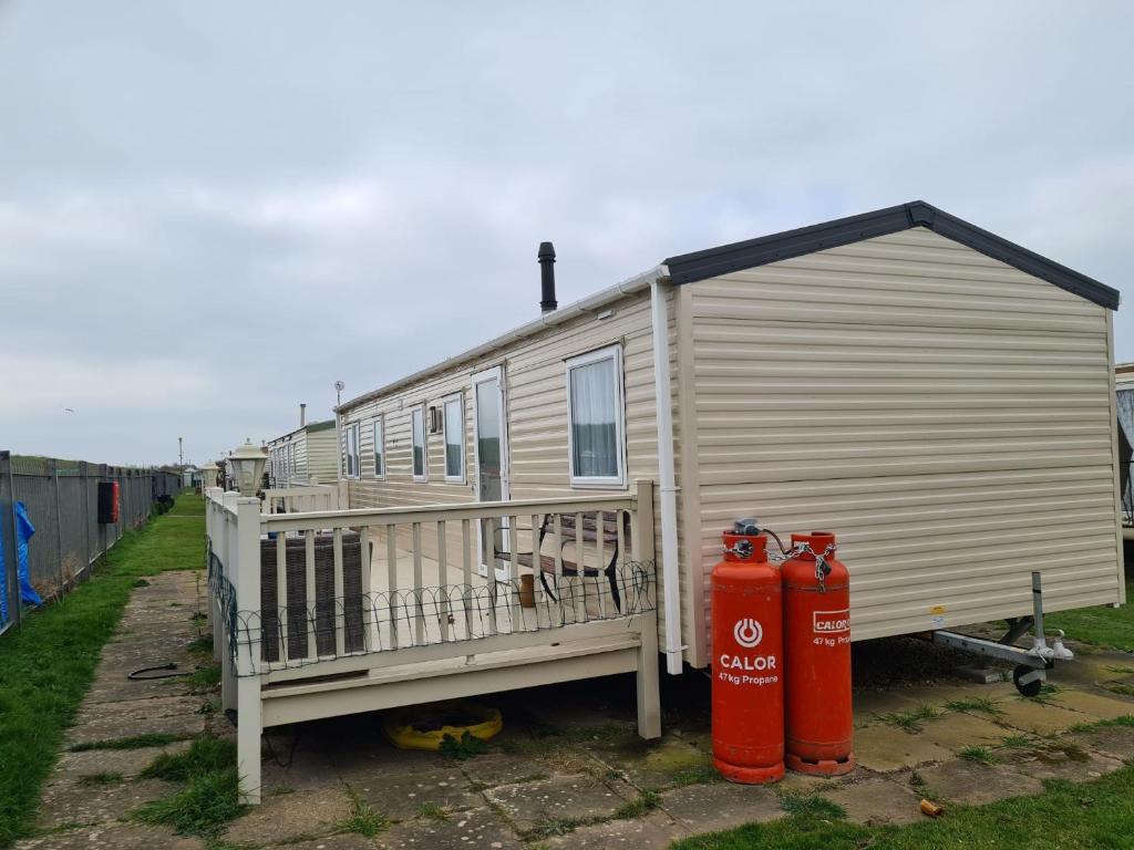 a tiny house with a fire hydrant next to it at 10 Berth on Seaview (Linwood) in Ingoldmells