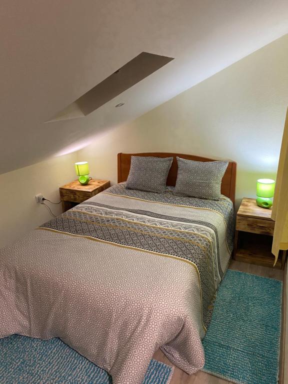a bedroom with two beds and two lamps on tables at Lovely newly refurbished, 1 bedroom top floor apartment with sea views, fast WI-FI CABLE TV and Netflix in Ribeira Brava