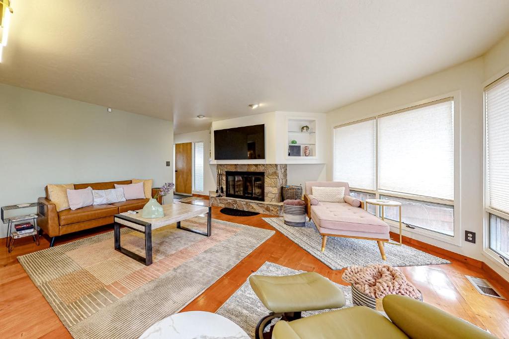 a living room with a couch and a fireplace at Cascade Canyon Home in Redmond