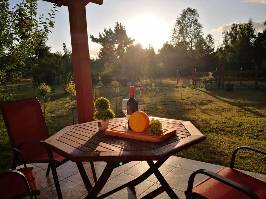 uma mesa de piquenique com uma garrafa de vinho e uma laranja em Tranquilidad y descanso en Villarrica - Pucón em Pucón