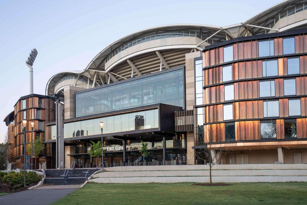 a large building with a large clock on the side of it at Oval Hotel at Adelaide Oval in Adelaide