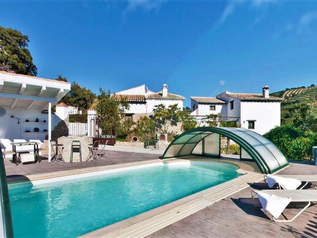 een zwembad voor een huis bij Traditional cottage in Andaluc a with private terrace in Serval
