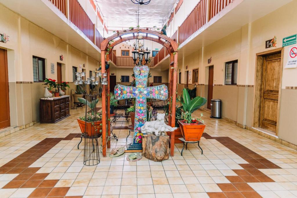 a large room with a cross and a altar at Hotel Cervantino in Tapachula